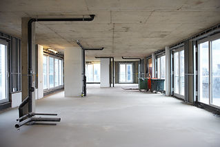 Empty construction site interior with unfinished concrete floor