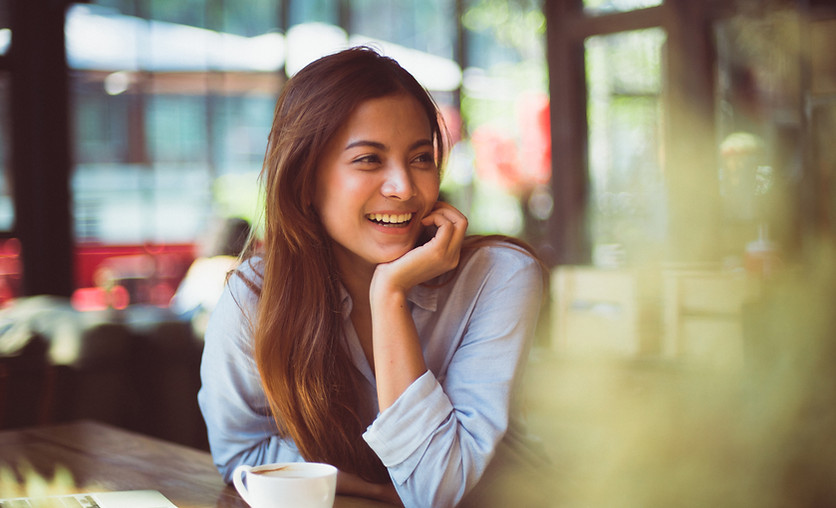 A woman smiling with happiness