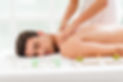 Man enjoying at spa with his eyes closed and getting back massage