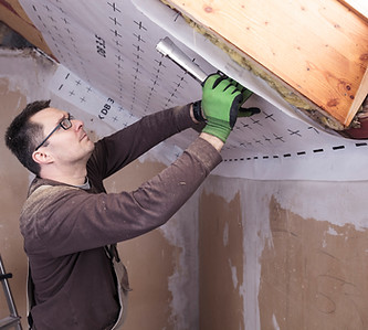 Workman removing spray foam
