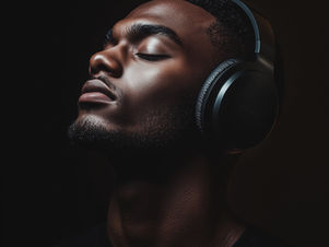 A person is listening to their voice recording with their eyes closed