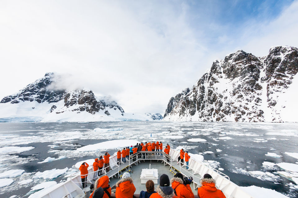 a group of tourists on a boat in Antarctica