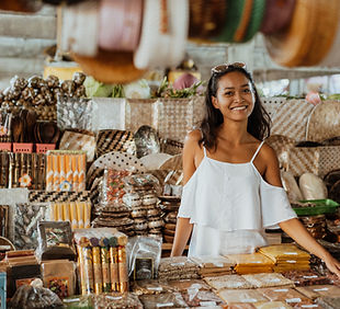 Una mujer de pie en una tienda de souvenirs.