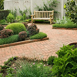A beautiful courtyard garden with brick pavement