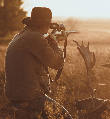 Hunter aiming a rifle