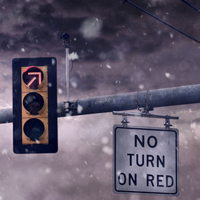 Red traffic light with no turn on red sign in a storm representing paused IEEPA tariff refund order