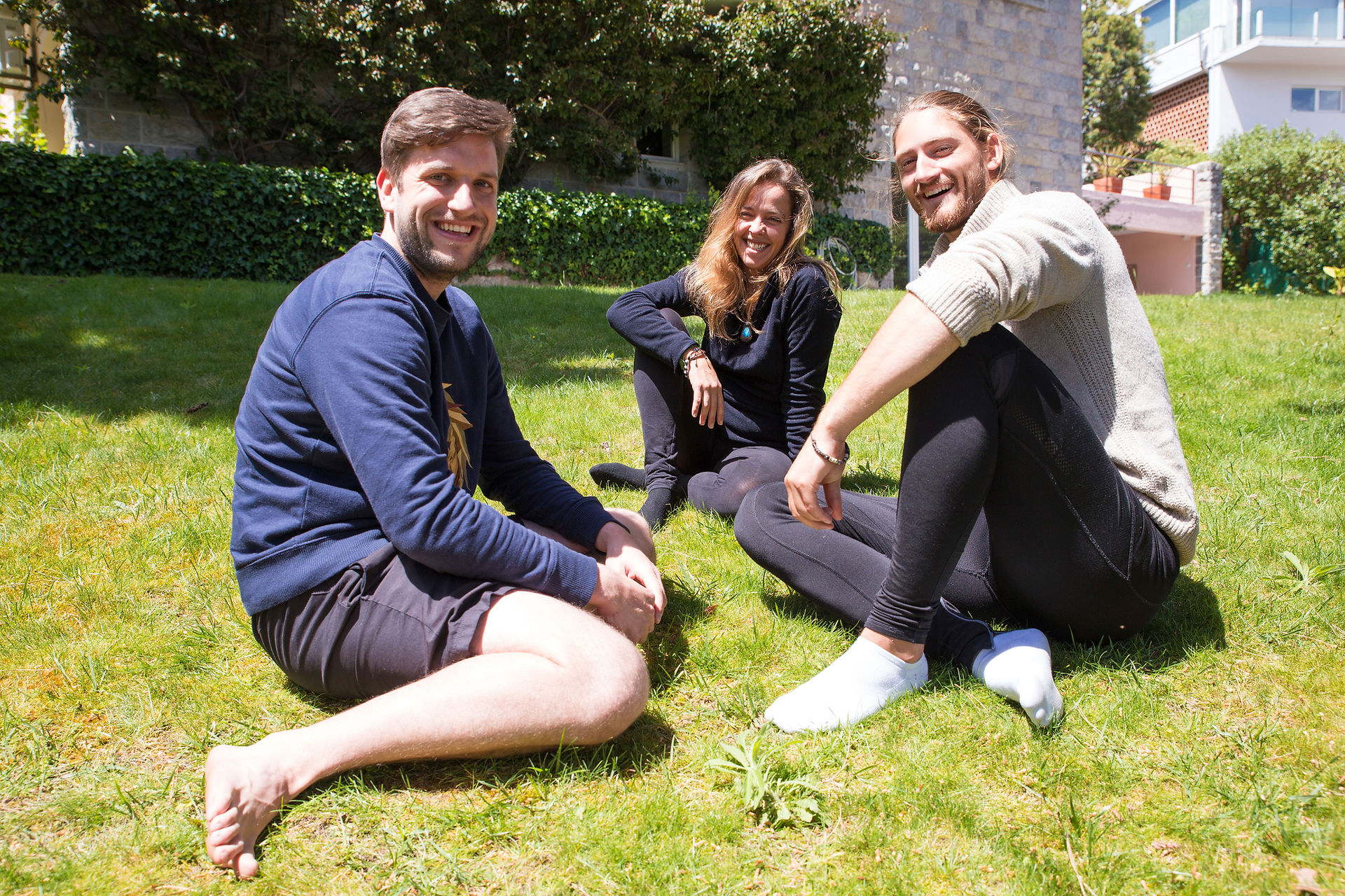 Three interns smiling outdoors