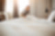 Maid working at a hotel making the bed