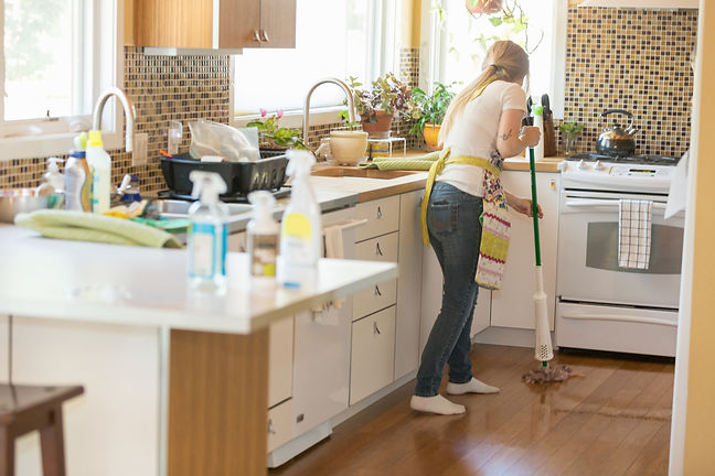 Young woman mopping with green cleaning products