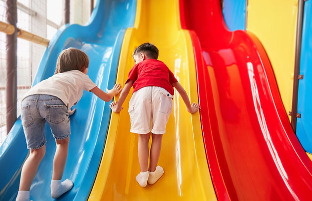 Boys Climbing Up Slide