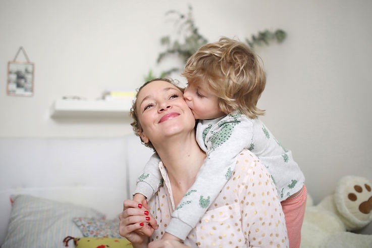 Loving Child giving mother a kiss
