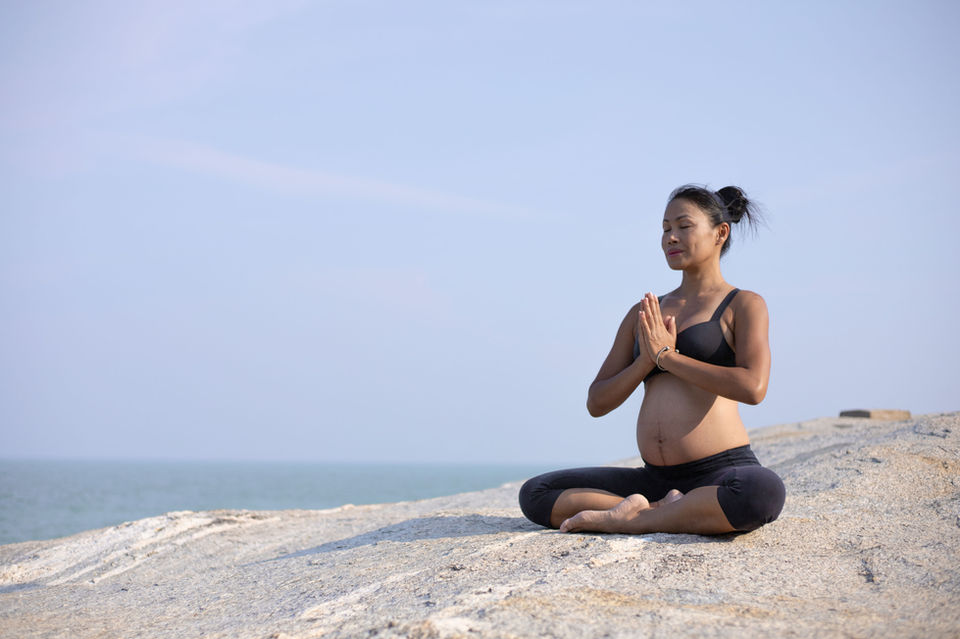 Maternity Photography by Blake Ferguson depicts a woman doing Yoga on the Beach during a Summer Day in Ontario, Canada.