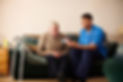 senior man with care worker at home