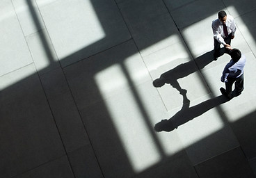 business partnership handshake in medical device consulting industry