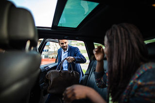 a man entering in taxi with a bag