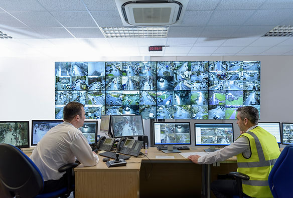 Security guards in a security control room with a video wall