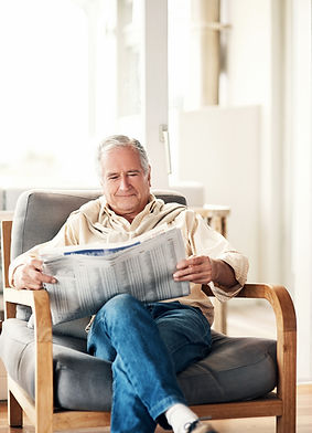 Shot of an elderly man reading a newspaper during a relaxing day at home