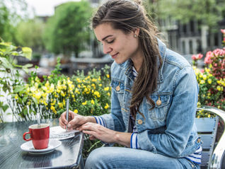 A woman realigning her priorities, writing a list to help her get work-life balance