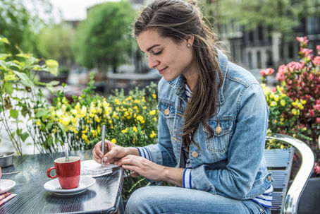 A woman realigning her priorities, writing a list to help her get work-life balance