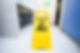 A bright yellow cleaning sign indicating a caution area for cleaning activities