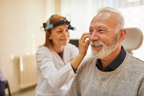 Doctor examining smiling patient