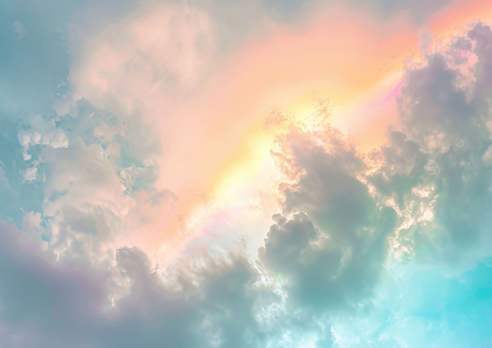 Bright rainbow shining through clouds.