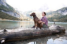 Woman with dog at a lake