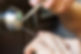 close up of locksmith hands using pick tools to open locked door