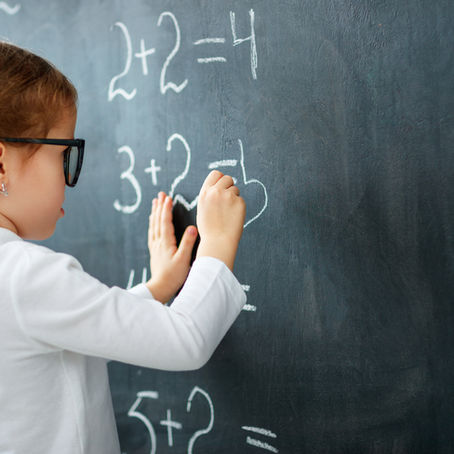 A brilliant mathematician working at a blackboard. In Kindergarten.
