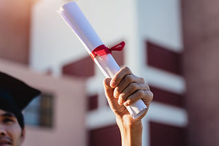 Close-up of a hand of student holding a degree certification