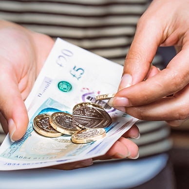A woman counting money for payment