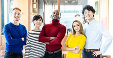 A waist up photo of five people in bright shirts