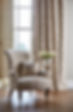An armchair with a clean cover and cushion in a living room