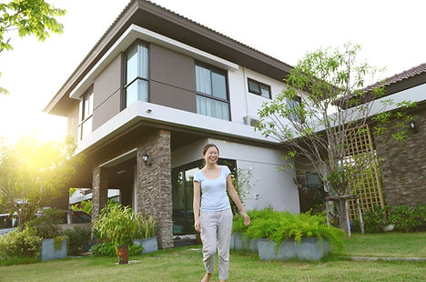 Person Standing In Front Of House
