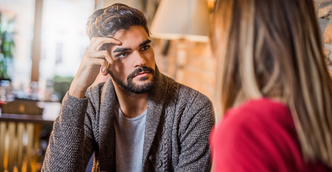 Young man listening to his girlfriend about her problems