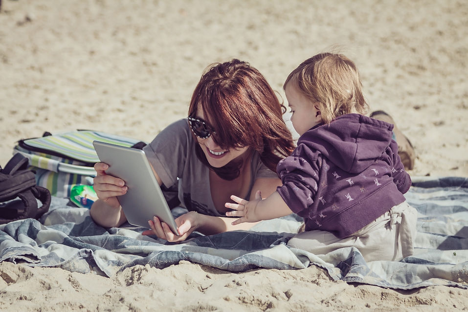 A woman enjoying time on Daytona Beach with her daughter knowing she booked a stress free cookout with Beach Barbecues.