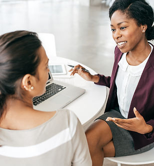 A woman meets with a professional member of her team