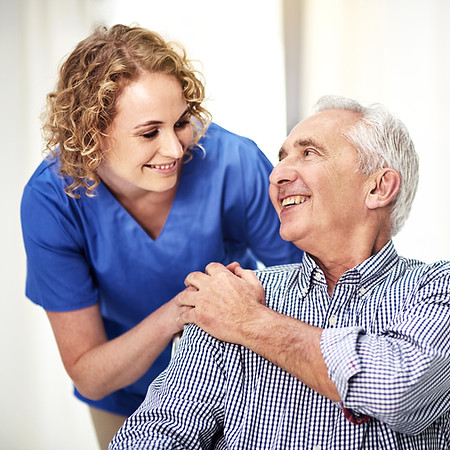 Shot of a female carer talking to her patient in the nursing home