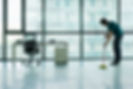 Janitor mopping empty office