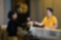 Female receptionist handing room key card to male guest