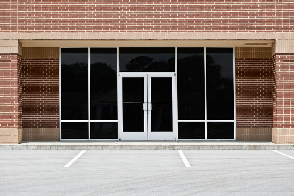 a generic, unoccupied commercial storefront or office space in a contemporary strip mall with red brick exterior walls