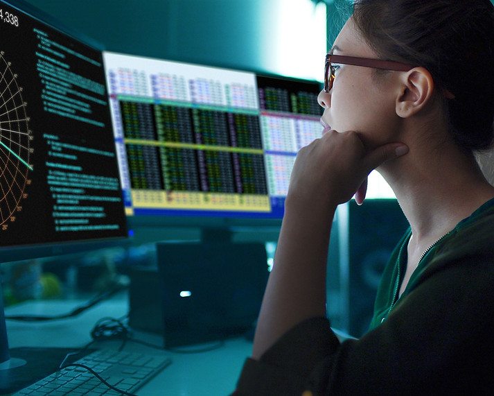 A woman looking at charts on the screen