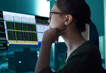 A woman looking at charts on the screen