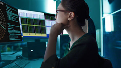 A woman looking at charts on the screen