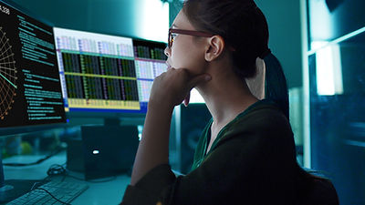 A woman looking at charts on the screen