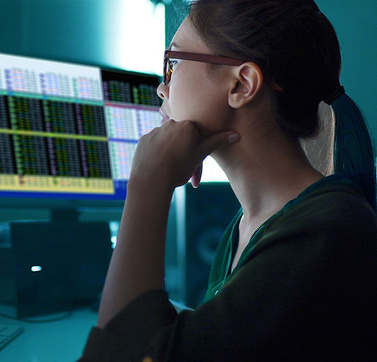 A woman looking at charts on the screen