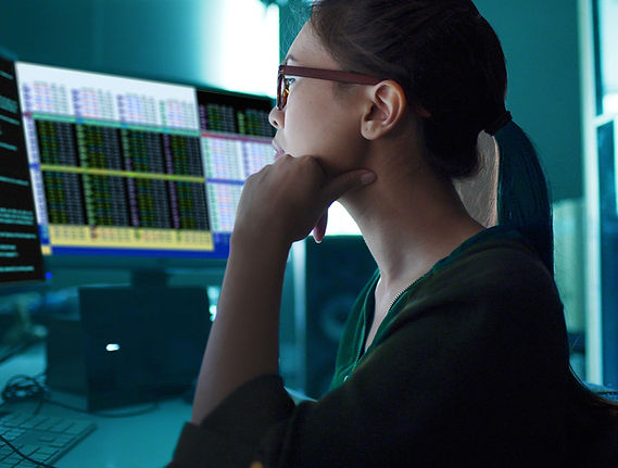 A woman looking at charts on the screen