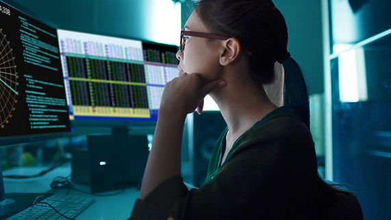 A woman looking at charts on the screen