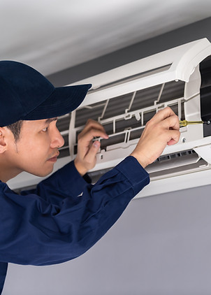 Technician Repairing Air Conditioner