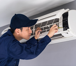 Technician Repairing Air Conditioner